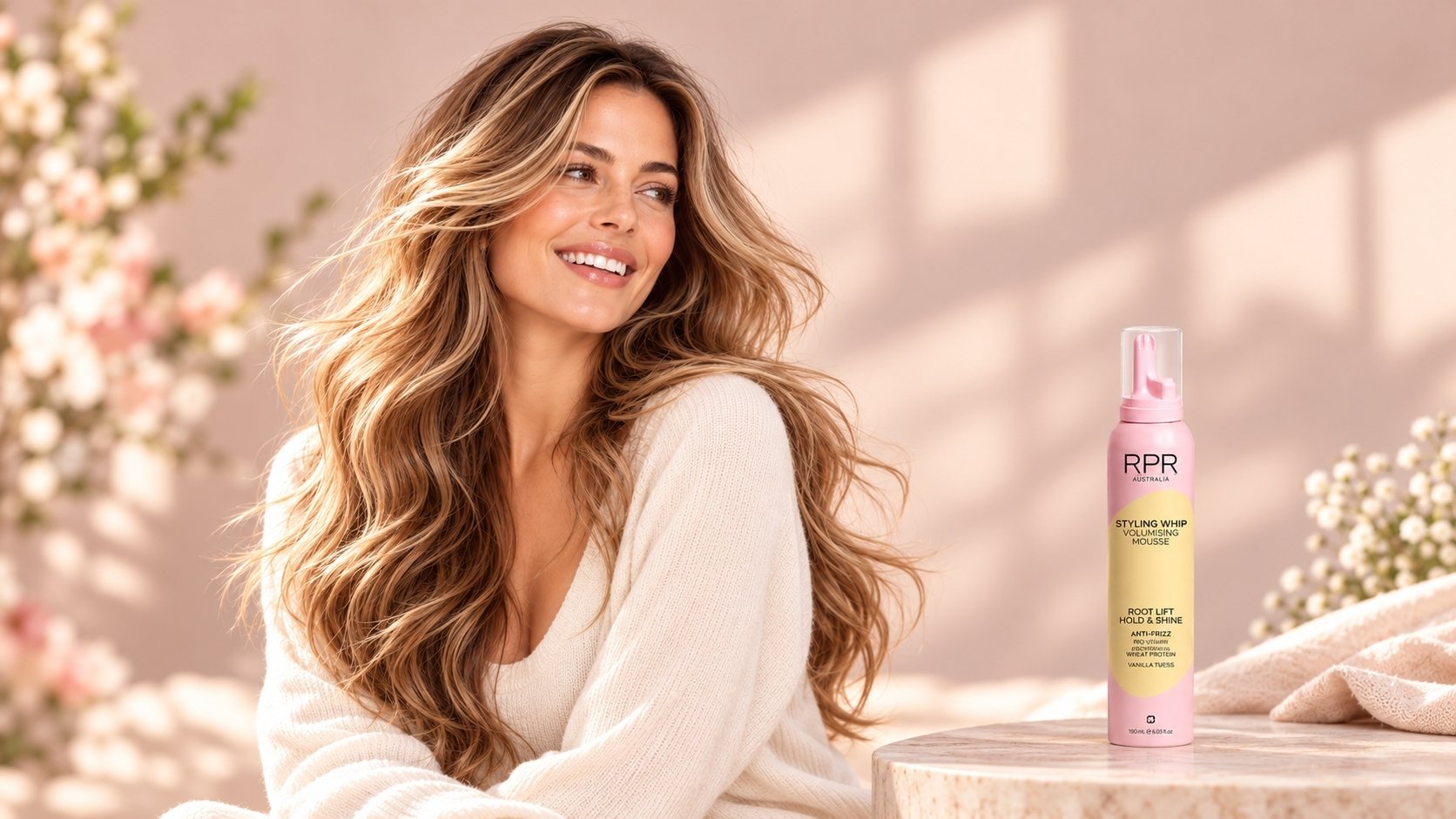 Woman with long, soft blonde waves beside RPR Styling Whip Volumising Mousse in a pastel spring setting.